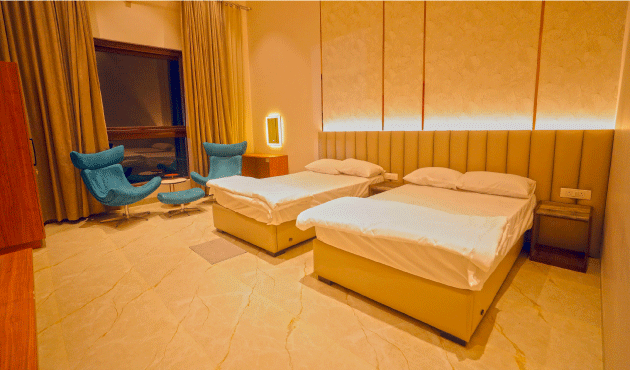 Long shadows stretching across Dhara’s lawn in late afternoon